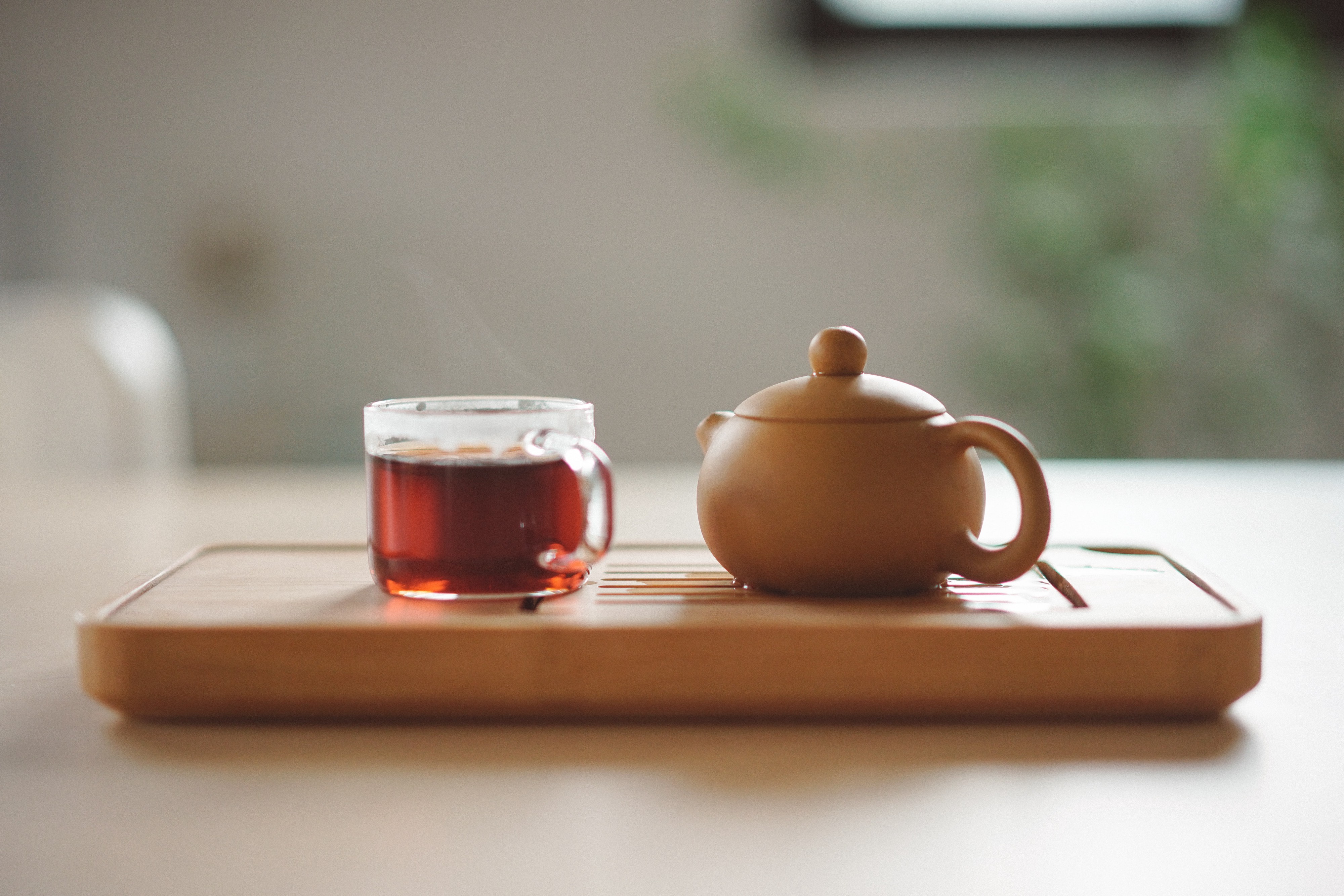 tray with glass mug and pot of tea